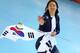 San Hwa Lee celebrates after setting an Olympic record.