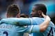 Manchester City's Yaya Toure, right, celebrates with teammates including Aleksander Kolarov, left, after scoring against Stoke during their English Premier League soccer match at the Etihad Stadium, Manchester, England, Saturday Feb. 22, 2014. (AP Photo/J