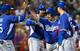 The Dodgers celebrate Alex Guerrero's grand slam against the Reds.