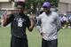 Xavier Lewis (left) stands with LSU defensive backs coach Corey Raymond (right).