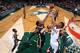 The Pacers' Ian Mahinmi (28) taps the loose ball away from Milwaukee Bucks forward Jeff Adrien.
