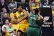 Andrew Bynum tries to establish low-post position against Jared Sullinger and Kris Humphries of the Boston Celtics on March 11.