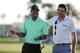 Keegan Bradley shares a laugh with Tiger Woods.