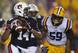 Auburn quarterback Nick Marshall looks to pass as LSU defensive end Jermauria Rasco chases him. Both will return this season, this time facing each other in Jordan-Hare.