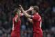 Liverpool's Jon Flanagan celebrates with team-mate Jordan Henderson.