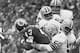 Jim Carter wraps up Larry Brown of the Redskins in 1972.