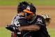 Jarrod Saltalamacchia, left, and Carlos Marmol share a hug. Does that mean they got a good grade as one of the Miami Marlins' offseason acquisitions?