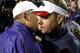 Les Miles (left) speaks with Ole Miss head coach Hugh Freeze (right).