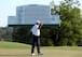 Fred Couples salutes the crowd around the 18th green.