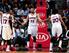 Hawks forward Mike Scott (middle) slaps hands with Louis Williams and Cartier Martin.