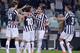 Juventus players surround Claudio Marchisio after his decisive strike in the Europa League quarterfinal against Lyon.