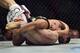 Joseph Benavidez applies the guillotine to Tim Elliott.