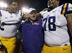 LSU left tackle La'el Collins (left), head coach Les Miles (center) and left guard Vadal Alexander (right) celebrate a victory.