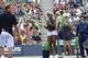 Serena Williams cheers on Andy Roddick during Kid's Day at 2005 U.S. Open.
