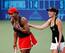 Serena Williams and Martina Hingis enjoying exhibition during World Team Tennis event in 2011.