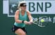 Eugunie Bouchard hits a shot against Simona Halep at Indian Wells.
