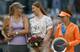 Maria Sharapova and former world No. 1 Dinara Safina chat as Simona Halep looks away during the trophy ceremony in Madrid.
