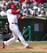 Oscar Taveras gets a hit in a 2013 spring training game against the Miami Marlins.