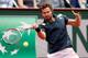 Ernests Gulbis swings his forehand during a match at the 2014 French Open.