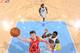 Omer Asik of the Houston Rockets throws down a dunk against the Nuggets defense.