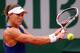Samantha Stosur readies for a backhand slice during her match against Maria Sharapova at the 2014 French Open.