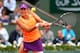 Garbine Muguruza goes for a backhand in her quarterfinals match against Maria Sharapova at the 2014 French Open.