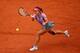 Li Na dashes toward the ball during her first-round loss at the 2014 French Open.
