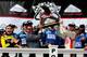 Dale Earnhardt Jr. (right) hoists the new Pocono Raceway trophy in Victory Lane.