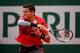 Milos Raonic hits a forehand in a match at the 2014 French Open
