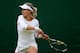 Eugenie Bouchard swings her racket during a match at 2013 Wimbledon.