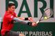 Milos Raonic aims for the ball during a 2014 French Open match.