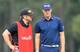 Caddie John Wood (left) consults with golfer Hunter Mahan after Friday's unthinkable gaffe.