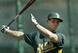 McKinney takes batting practice with the A's.