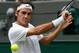 Roger Federer prepares to hit a backhand slice during his first-round match at Wimbledon.