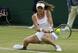 Agnieszka Radwanska gets low to hit a backhand in her first-round match.