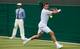 Stanislas Wawrinka prepares to swing his backhand during first-round match at Wimbledon.