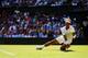 Rafael Nadal gets real low to make a play on the ball during his first-round match at Wimbledon, 2014.