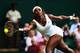 Serena Williams reaches for the ball during her first-round match at 2014 Wimbledon.
