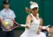 Sabine Lisicki hits a forehand during a match in the first week of the 2014 Championships, Wimbledon.