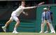 Andy Murray leans to make a play on the ball during a second-round match at Wimbledon.