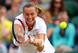 Petra Kvitova reaches to meet the ball during fourth-round match at Wimbledon.