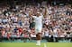 Roger Federer recognizes applause from Wimbledon crowd after winning quarterfinal match.