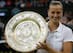 Petra Kvitova holds up trophy after winning her second Wimbledon title.
