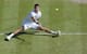 Grigor Dimitrov tries an acrobatic shot during the Wimbledon semifinal.