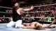 Bray Wyatt celebrates in front of a fallen Daniel Bryan.