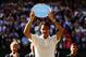 Roger Federer holds up the runner-up trophy at Wimbledon.