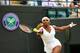 Serena Williams reaches to make a play on the ball during a Wimbledon match.