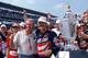 Dale Jarrett (right) poses with his father, Ned, and the winning trophy after capturing the 1996 Brickyard.