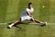 Grigor Dimitrov tries to slide his way to the ball during the Wimbledon semifinals.