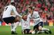 Fredi Kanoute and Michael Carrick congratulate Erik Edman after he scored a spectacular long-range goal versus Liverpool.